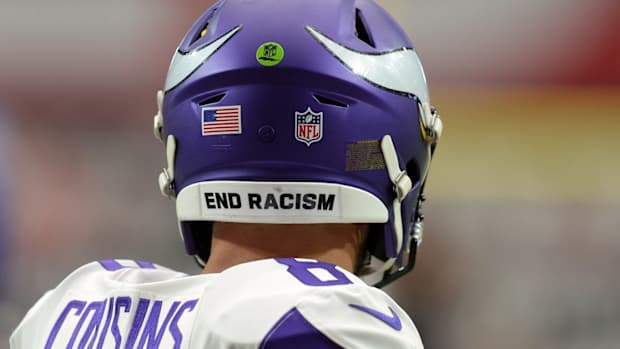Sep 19, 2021; Glendale, Arizona, USA; An END RACISM sticker is shown on the helmet of Minnesota Vikings quarterback Kirk Cousins (8) prior to the game against the Arizona Cardinals at State Farm Stadium.